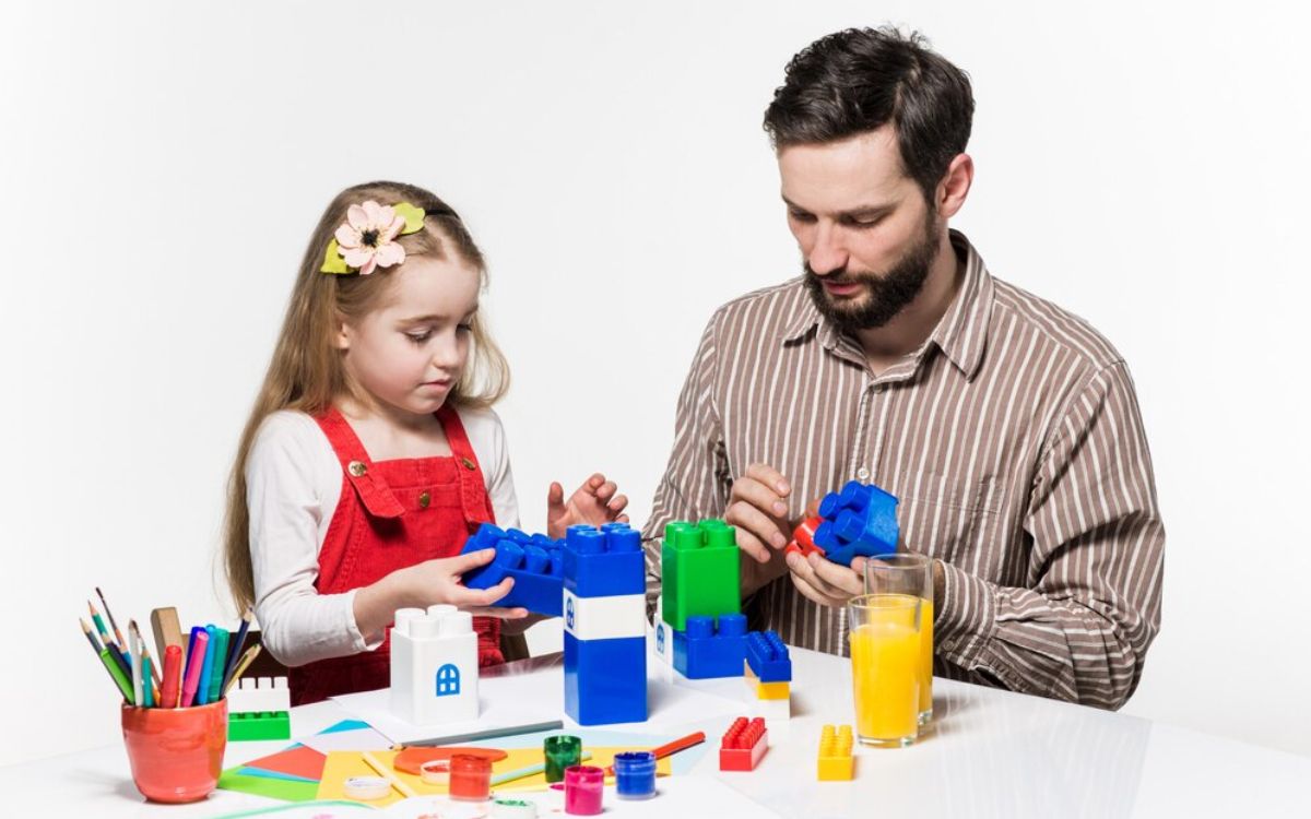 Child playing with building blocks, art supplies, and pretend play toys, enhancing creativity and imagination through hands-on activities.